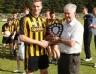 Ballycastle captain Brian McLernon receives Junior Football Feis Shield from North Antrim Chairman James McClean